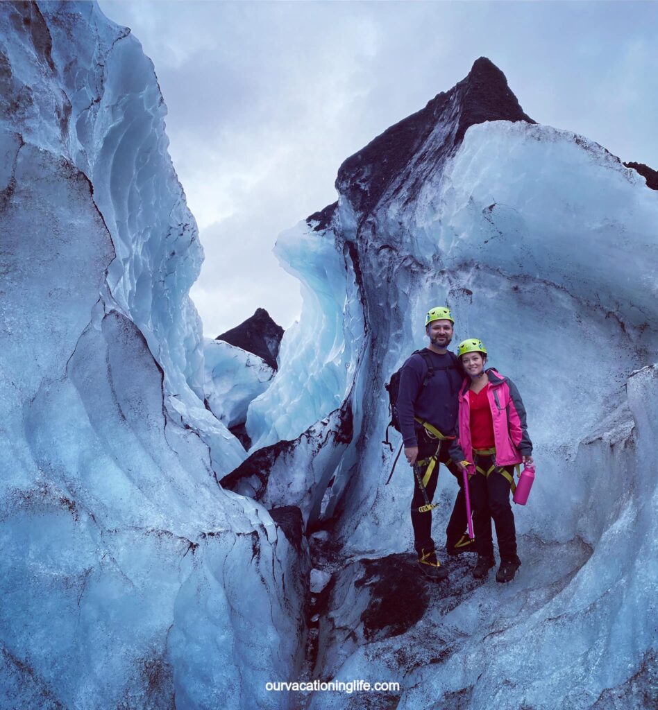 A couple hiking Solheimajokull glacier in the south coast of Iceland