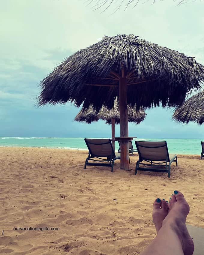 a hut and chairs on the beach