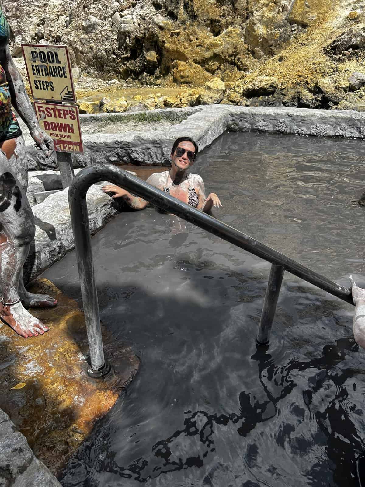 a woman in the mud baths at Sulphur Springs St. Lucia