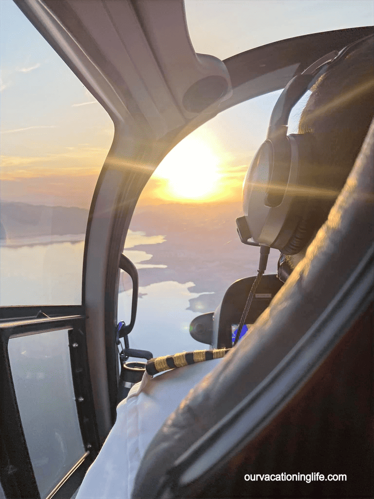 a helicopter pilot looks out his windshield at the sunset over Las Vegas and the Grand Canyon