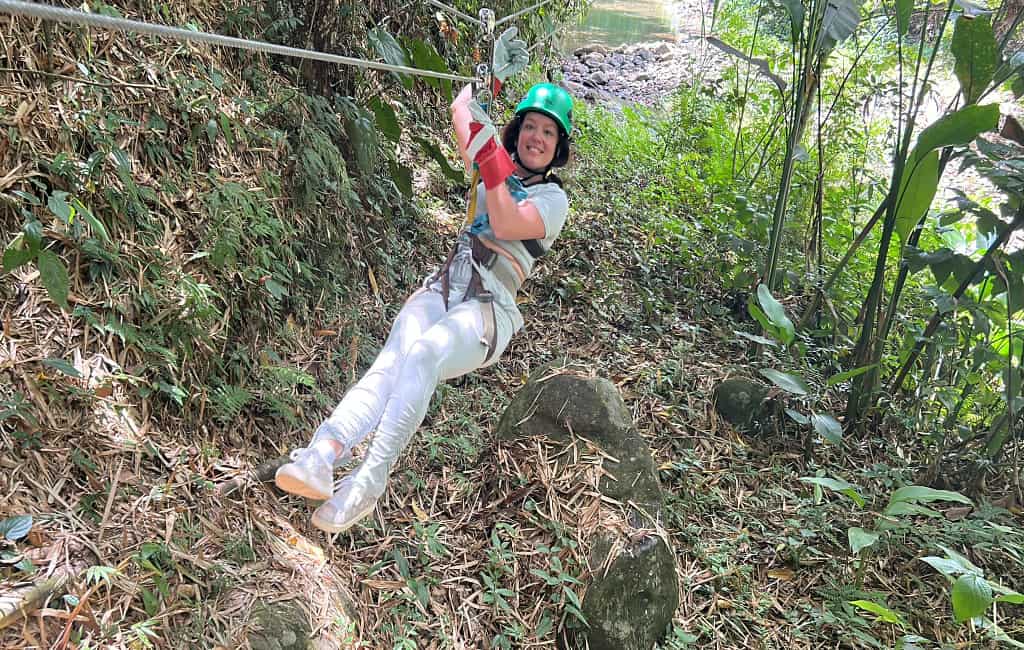 a woman zip lining in the jungle on a St. Lucia excursion