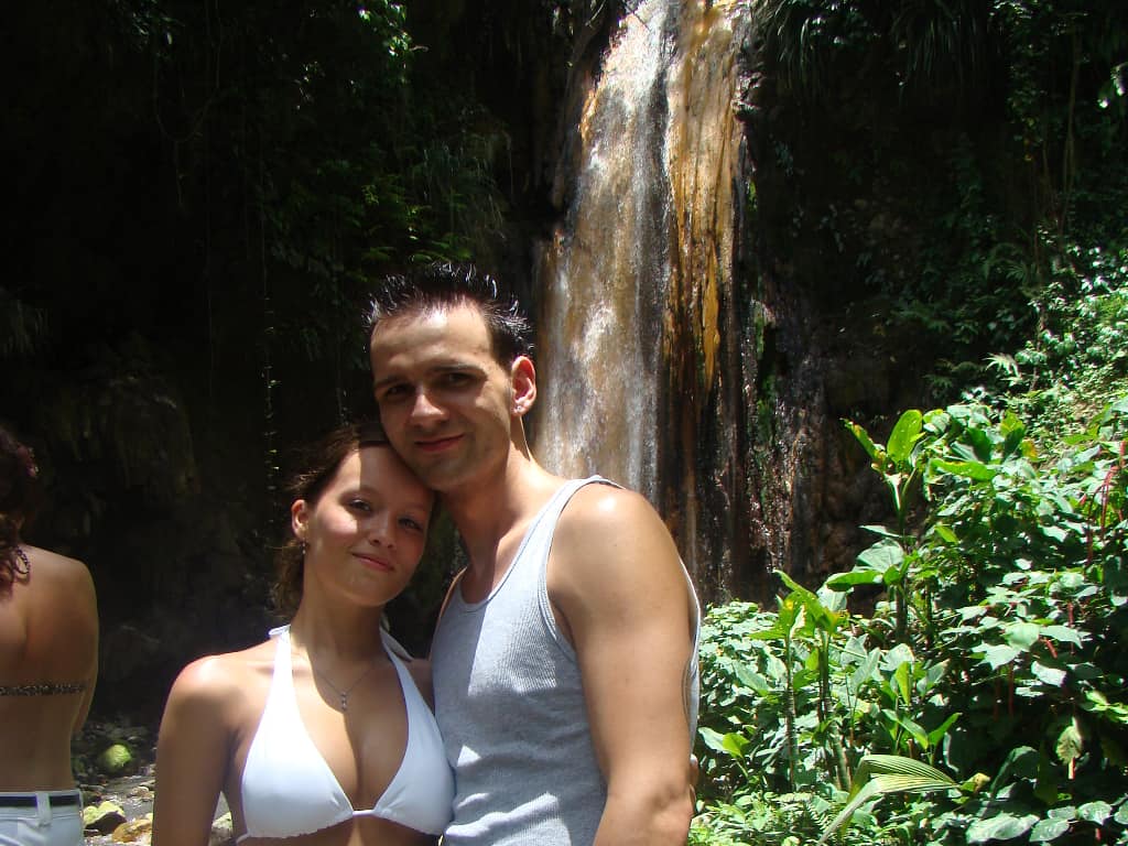 a couple standing in front of the Diamond Falls in St. Lucia
