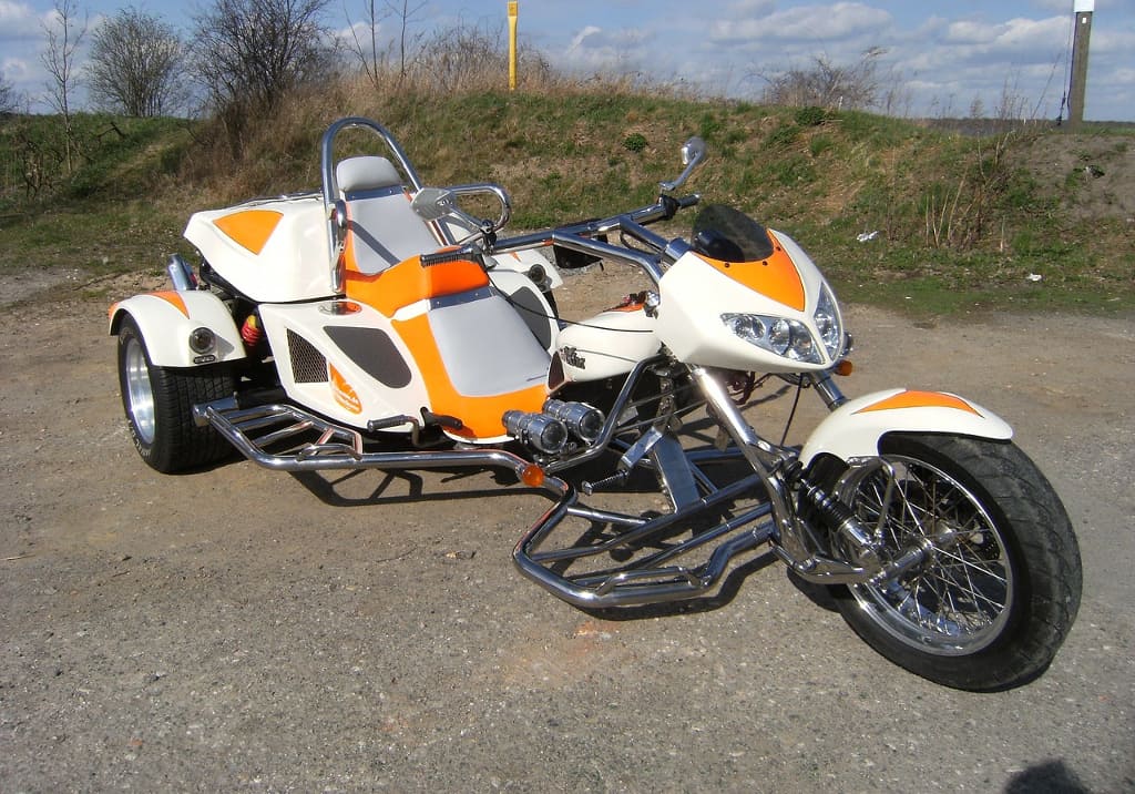 a white and orange trike motorbike