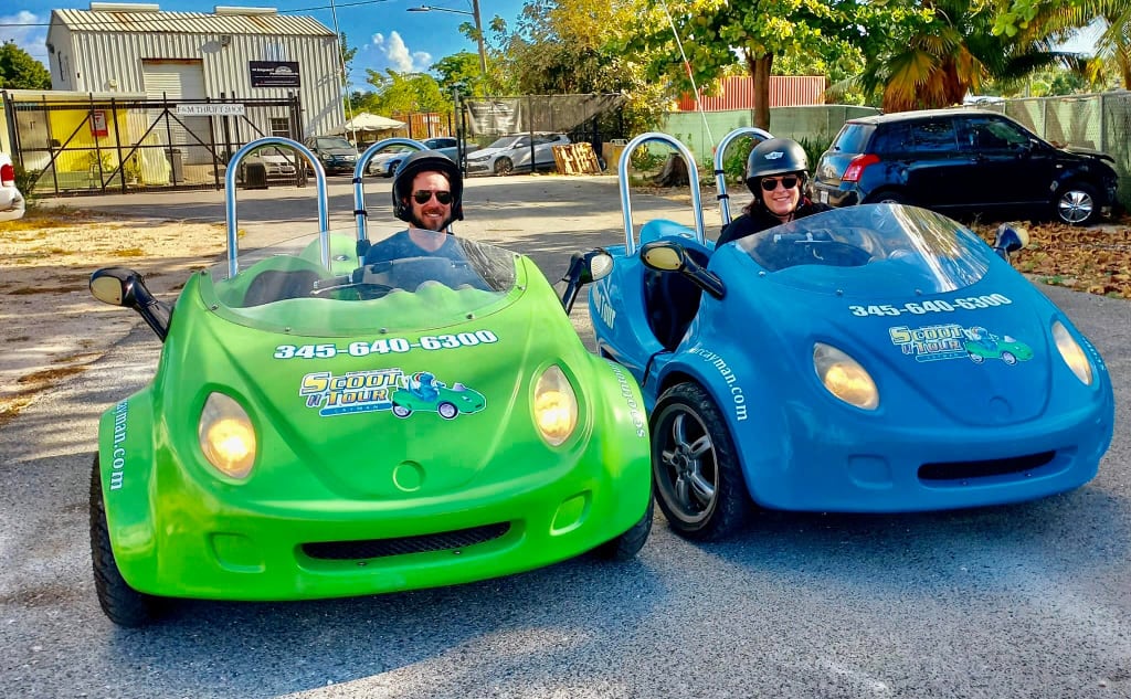 two people on colorful car scooters