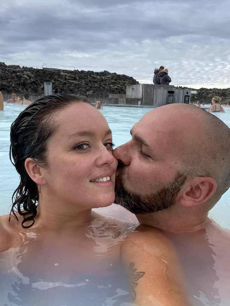 a man kisses a woman in the Blue Lagoon Iceland