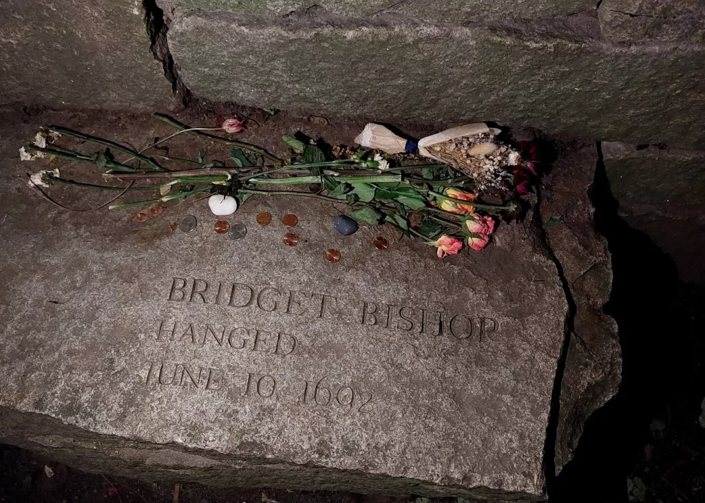 bridget bishop memorial stone with flowers and herbs