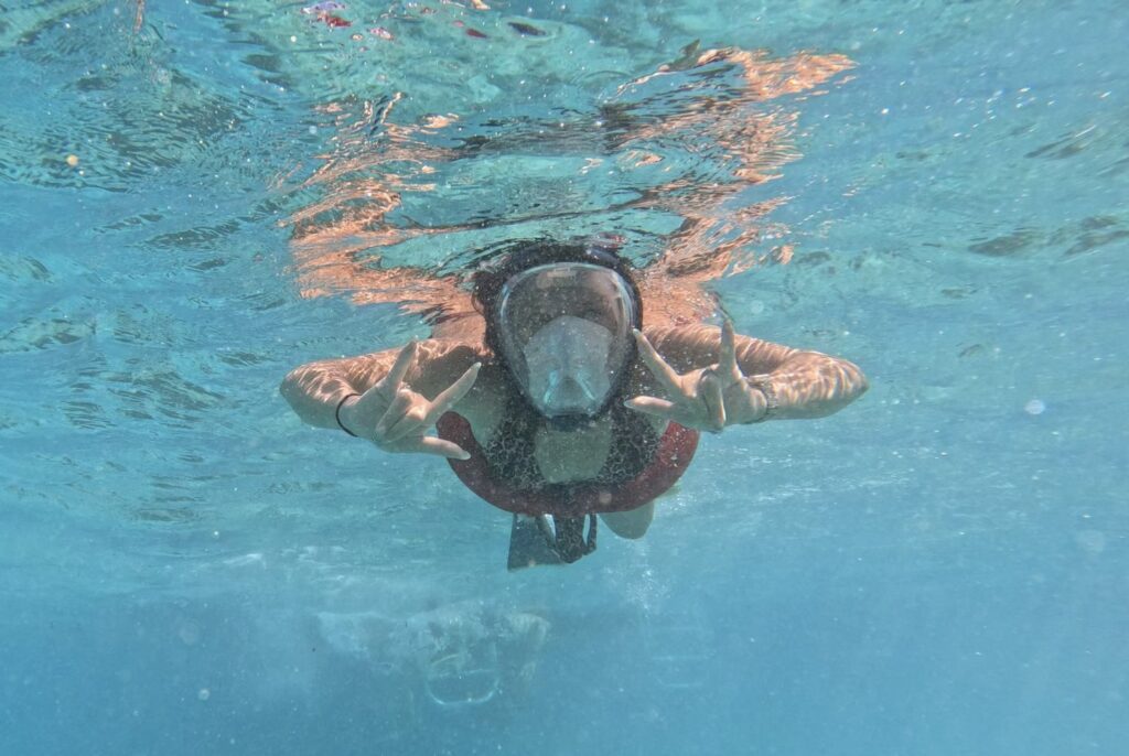 a woman snorkeling under the water