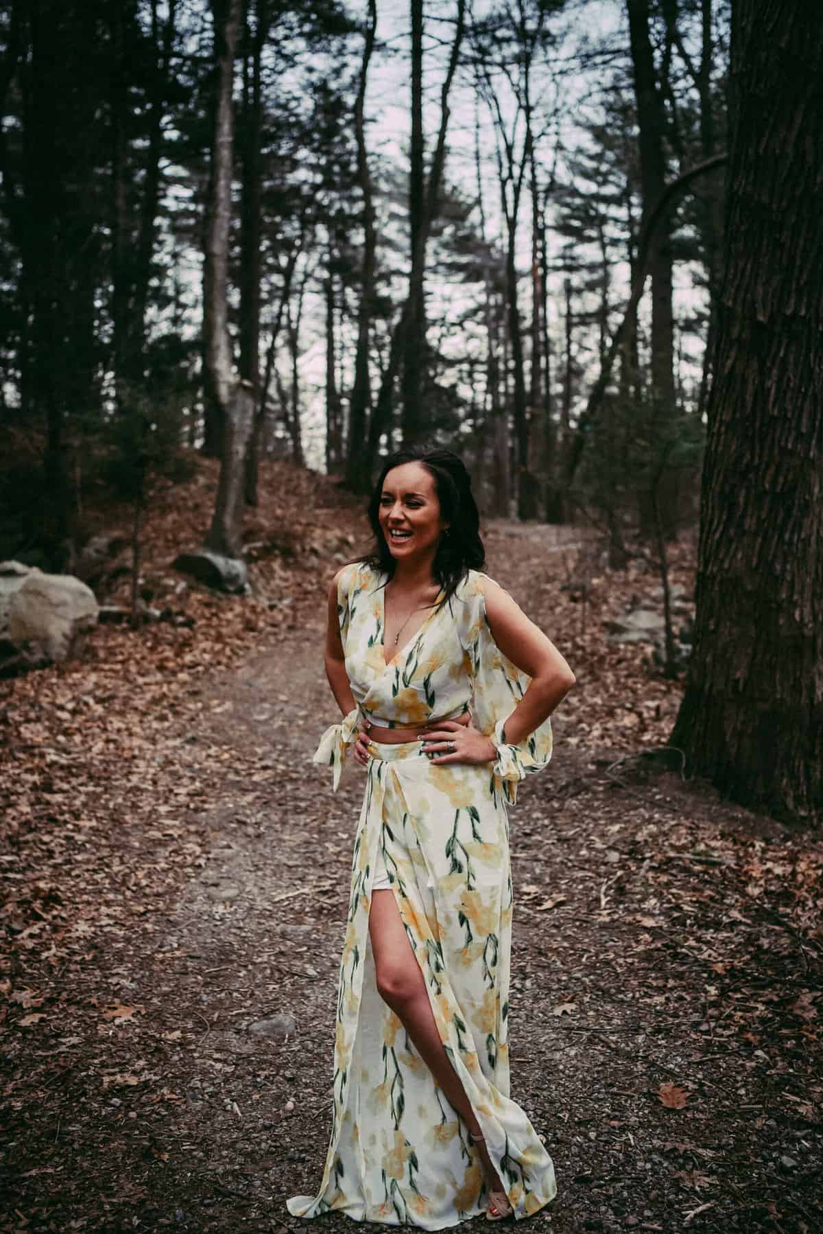 a smiling woman in the woods