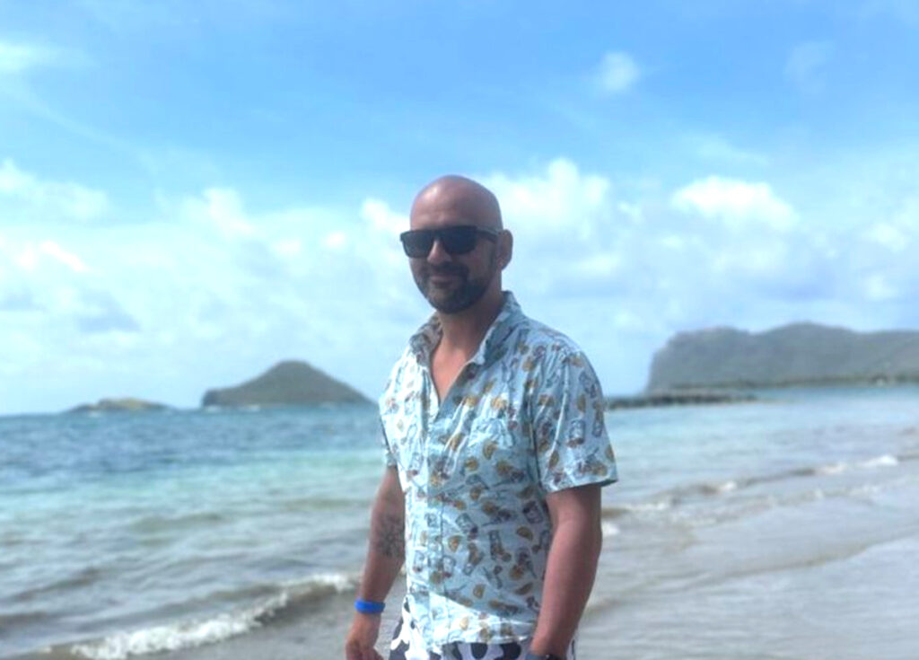 beach gear must haves include these Bluetooth sunglasses on a man at the beach